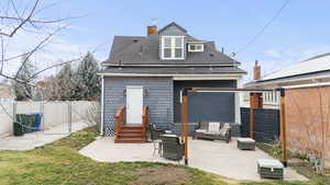 Back of house with a gate, a fenced backyard, a patio, roof with shingles, and an outdoor living space