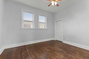 Spare room featuring ceiling fan and dark wood finished floors