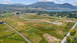 Expansive land parcel featuring open fields, existing roadways, and development in progress