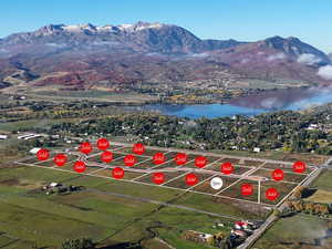 Aerial view of property and surrounding area featuring a water and mountain view