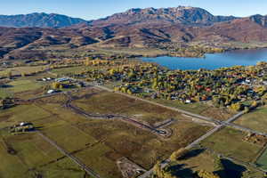 Expansive undeveloped land featuring a partial road infrastructure, surrounded by natural terrain