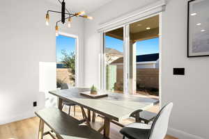 Dining room featuring light wood-style floors and a chandelier