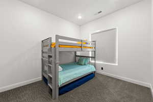 Bedroom featuring dark carpet and recessed lighting