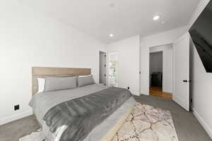 Bedroom featuring carpet flooring, recessed lighting, and connected bathroom