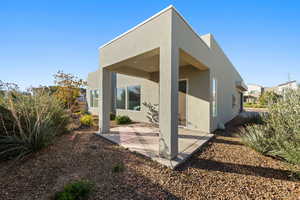 Rear view of property with a patio and stucco siding