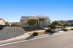 Modern home featuring driveway and stucco siding