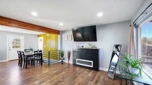 Living area featuring recessed lighting, wood finished floors, and a glass covered fireplace