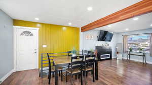 Dining space with beam ceiling, recessed lighting, dark wood-style floors, and a textured ceiling