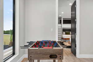 Playroom featuring light wood-type flooring and recessed lighting