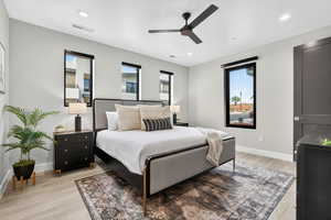 Bedroom featuring light wood-type flooring, ceiling fan, and recessed lighting