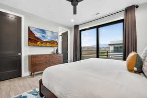 Bedroom with access to outside, light wood-style flooring, ceiling fan, and recessed lighting