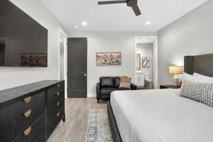 Bedroom featuring recessed lighting, a ceiling fan, ensuite bath, and light wood-type flooring