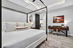 Bedroom featuring light wood-style floors, a ceiling fan, a desk, and recessed lighting