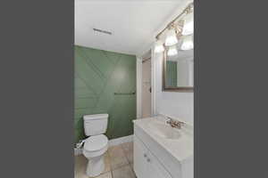 Full bathroom featuring vanity, light tile patterned floors, and a shower