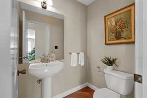 Bathroom featuring wood finished floors and baseboards