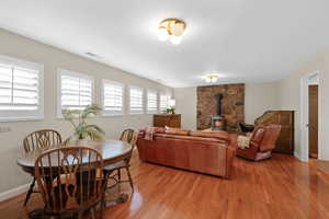 Living area featuring a wood stove and wood finished floors