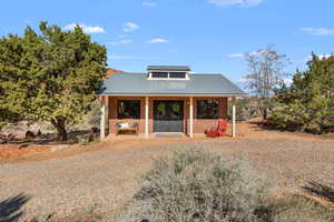 View of front facade featuring a metal roof and covered porch