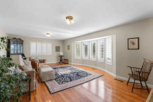 Living area featuring light wood-style floors and baseboards