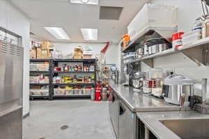 Kitchen featuring stainless steel counters and a paneled ceiling