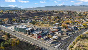 Aerial view of property and surrounding area with a mountainous background