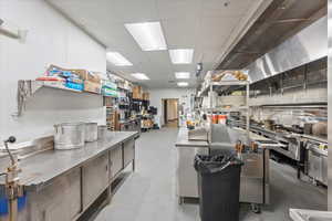 Kitchen featuring stainless steel counters and a paneled ceiling