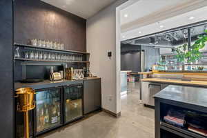 Indoor dry bar featuring open shelves, ventilation hood, recessed lighting, and wine cooler