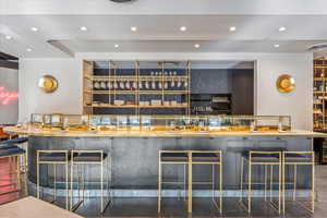 Community bar area featuring recessed lighting and open shelves