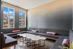Living room featuring concrete flooring and a mountain view