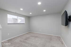 Spare room with light colored carpet and recessed lighting