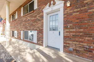 Doorway to property with brick siding
