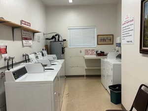 Shared laundry room with separate washer and dryer and water heater