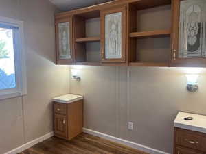 Bathroom featuring dark wood-style flooring and baseboards