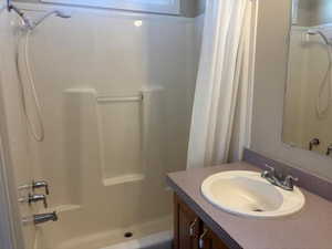 Full bath featuring vanity and shower / tub combo