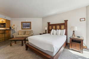 Bedroom featuring light colored carpet