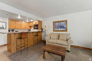 Living room featuring baseboards and light tile patterned floors