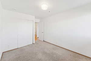 Unfurnished bedroom featuring a closet and carpet
