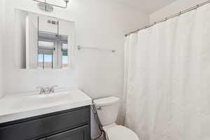 Bathroom with curtained shower and vanity