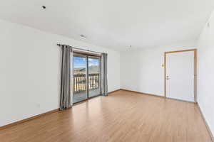 Spare room featuring light wood-style flooring and a mountain view