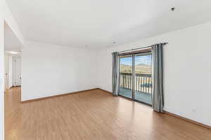 Unfurnished room featuring light wood-style flooring and a mountain view