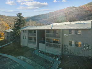Back of property featuring a mountain view and a balcony