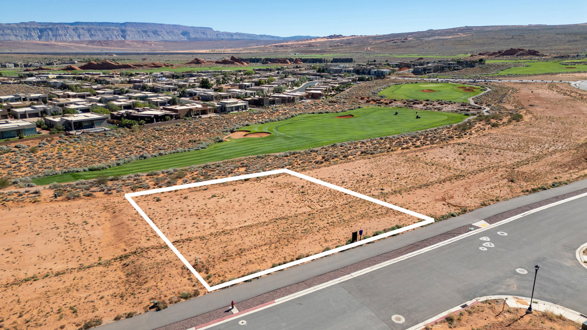 Aerial perspective of suburban area with a mountainous background and property boundaries highlighted