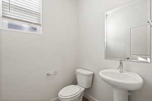 Half bath with toilet and baseboards