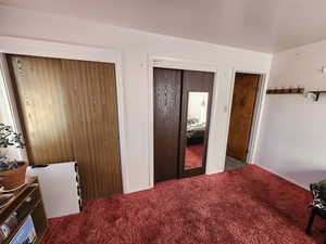 Bedroom featuring carpet flooring and baseboards