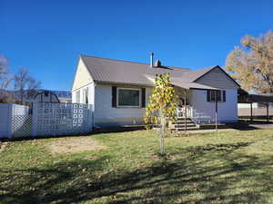Back of property featuring a metal roof
