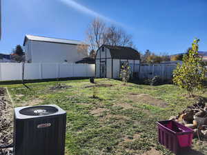 Fenced backyard with a storage unit