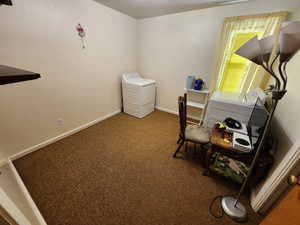 Carpeted office space featuring baseboards