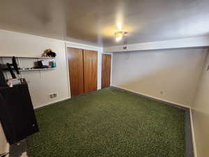Unfurnished bedroom featuring a closet and baseboards