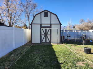View of shed with a fenced backyard