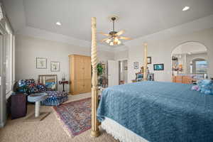 Bedroom featuring carpet, recessed lighting, ceiling fan, and arched walkways