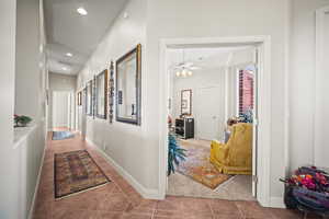 Corridor featuring dark tile patterned floors and recessed lighting